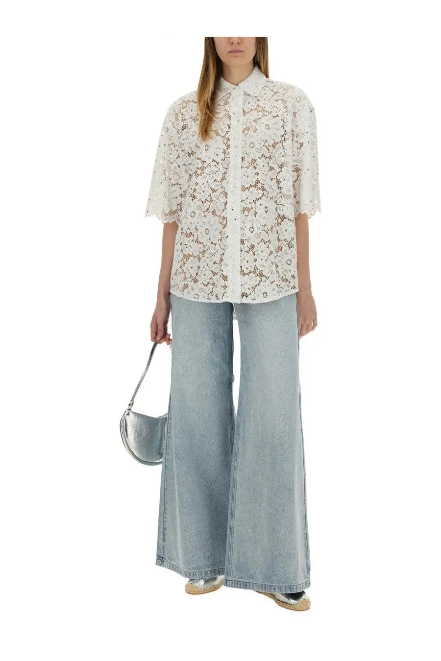 White lace button-up shirt with floral embroidery and short sleeves paired with michael kors women’s blue wide leg jeans