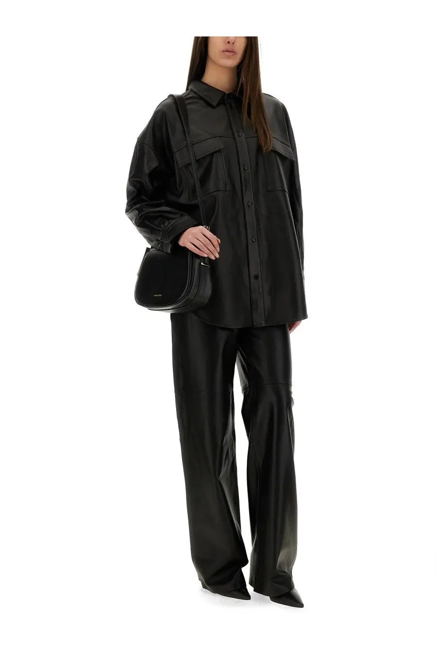 Black leather crossbody bag with sleek minimalist design and subtle stitching complementing michael kors jacket