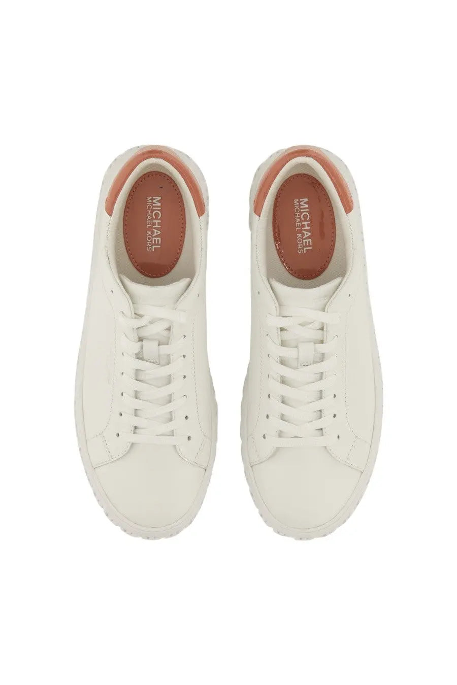 White leather michael kors women’s sneaker with tan accents on heel and insole visible from the back side