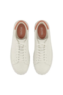 White leather michael kors women’s sneaker with tan accents on heel and insole visible from the back side
