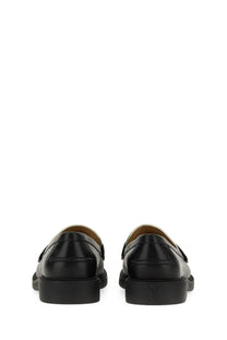 Michael kors women’s black leather loafers with glossy finish and contrasting tan lining for stylish wear