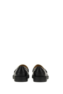 Michael Kors women’s black leather loafers with a sleek polished finish and classic slip-on design