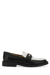 Michael Kors women’s black and white leather loafer with gold-tone logo on strap for stylish casual wear
