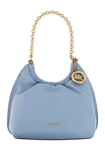 Light blue michael kors women’s medium indie handbag with gold chain strap and circular mk logo charm