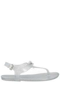 Michael Kors women’s monogram sandal in silver with clear glittery jelly material and t-strap buckle detail