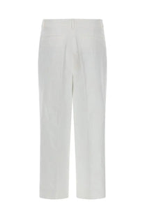 White straight-leg trousers by michael kors in linen with a clean minimalist design and subtle back pleats visible