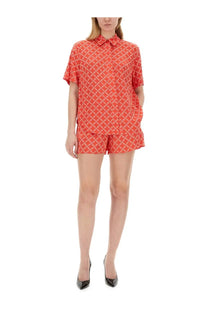Michael Kors women’s coral red short-sleeved button-up shirt with subtle geometric pattern and matching shorts