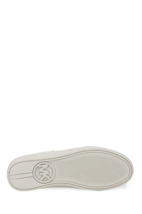 White rubber sole with subtle texture and michael kors logo embossed in center of michael kors women’s sneaker scotty yellow