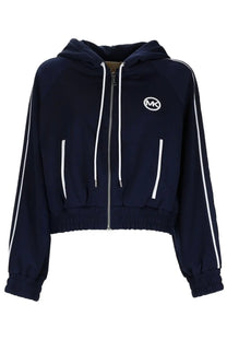 Navy blue michael kors women’s sports top with zip-up front, white side stripes, and front logo patch