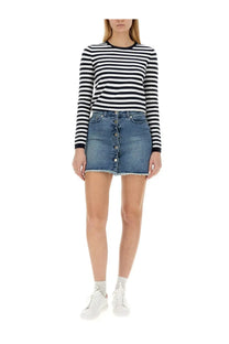 Blue denim mini skirt with button front and frayed hem paired with michael kors womens multicolor striped shirt