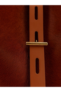Tan leather belt with gold tone bar buckle paired with minobossi women’s liz pony skin shoulder bag beige