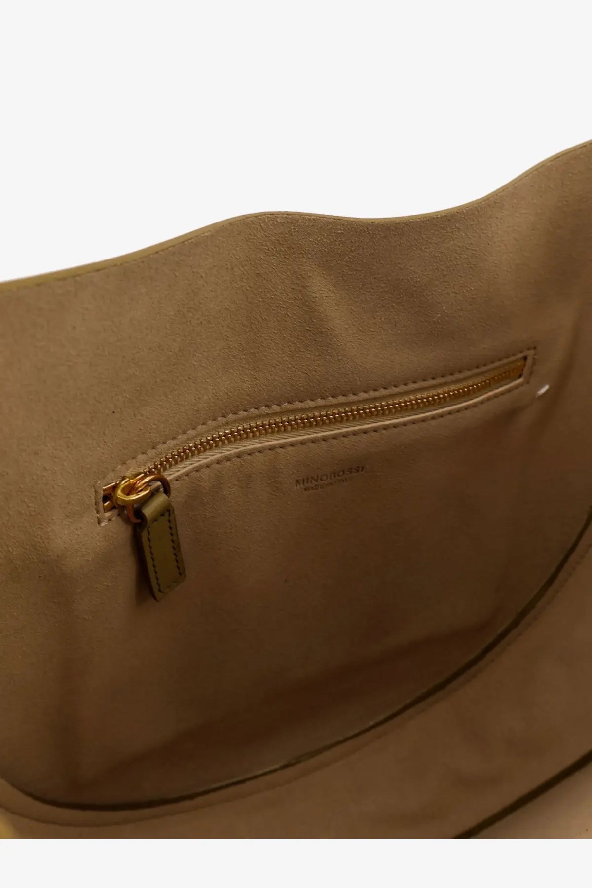 Beige suede interior of miu miu handbag with gold tone zipper and subtle brand embossing in green leather crossbody bag