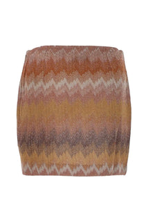 Missoni women’s shimmering high-waisted mini skirt with bold zigzag pattern in rust gold and muted pink tones
