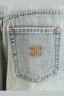 Light-wash cotton blue miu miu women’s jeans back pocket with orange embroidered miu miu logo