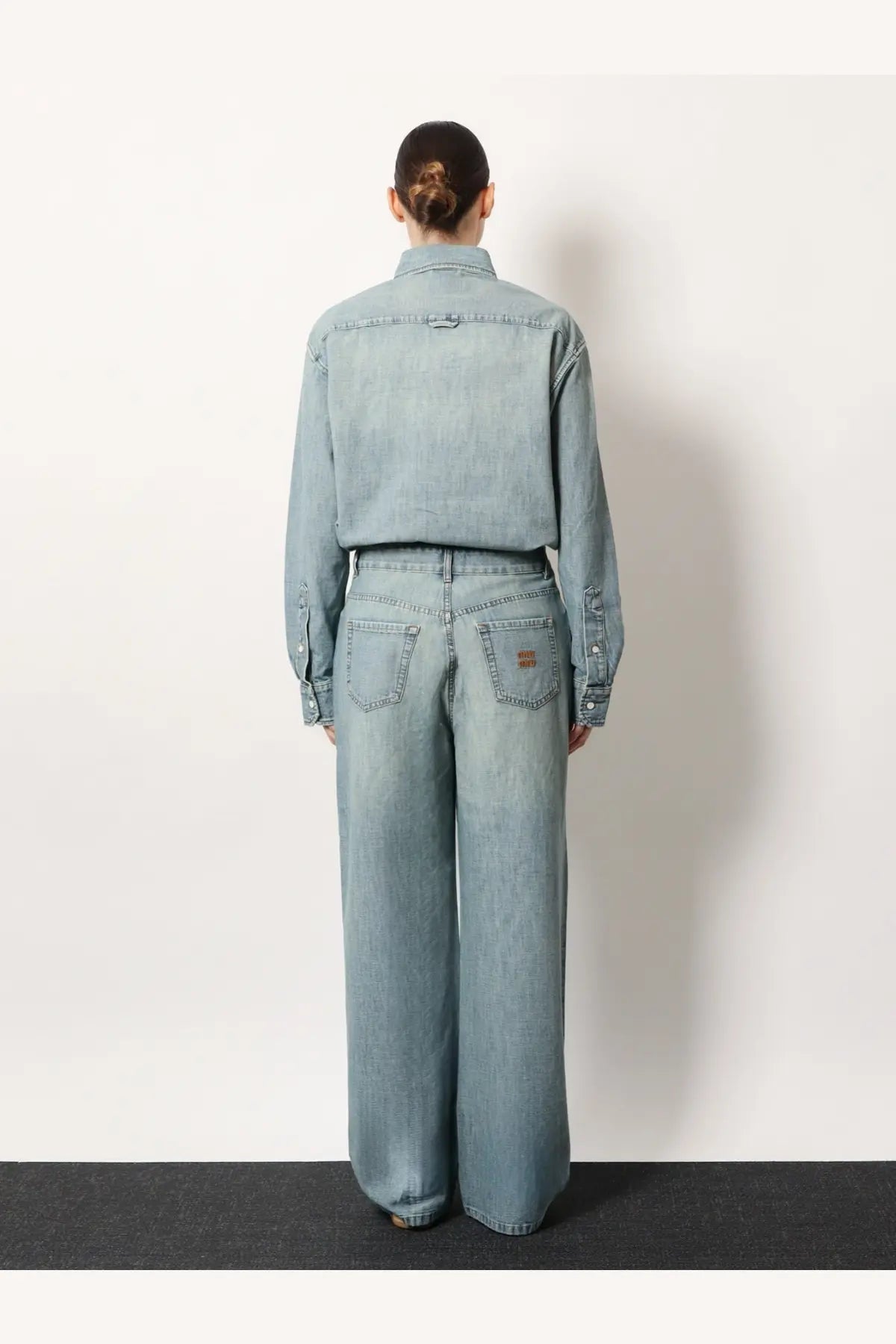 Miu Miu women’s cotton light-wash denim jeans with a relaxed wide-leg cut and subtle stitching details