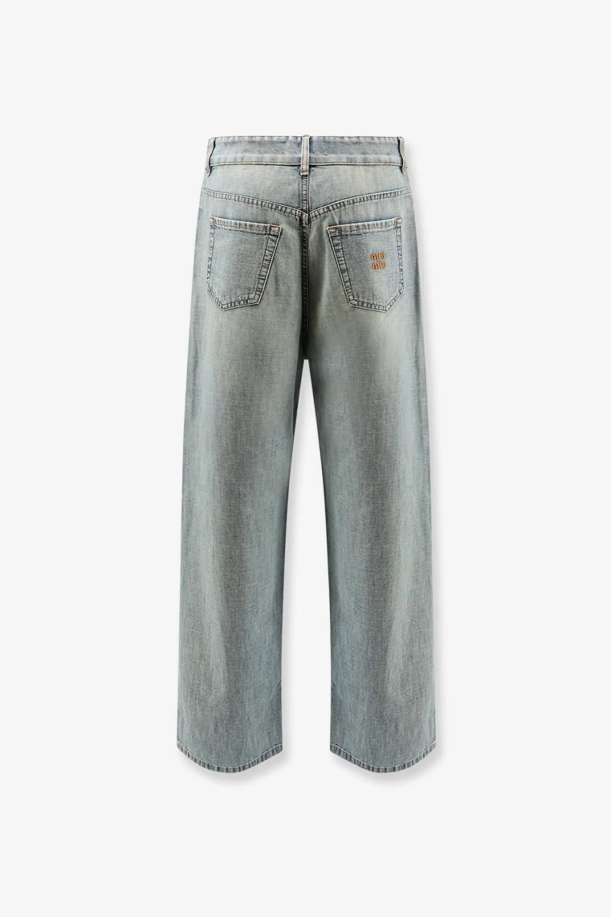 Back view of miu miu women’s light-wash cotton jeans with wide-leg cut and brown logo patch on right back pocket