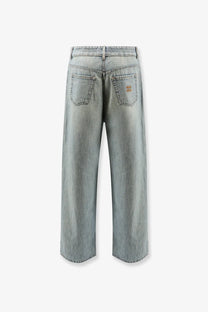 Back view of miu miu women’s light-wash cotton jeans with wide-leg cut and brown logo patch on right back pocket