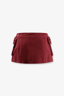 A sleek deep red satin finish Miu Miu women’s cotton mini skirt with decorative side ties