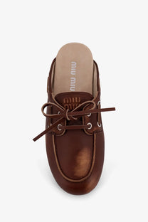 Miu Miu women’s beige brown leather mule shoe with tied bow and silver eyelets in Élavé sabot style
