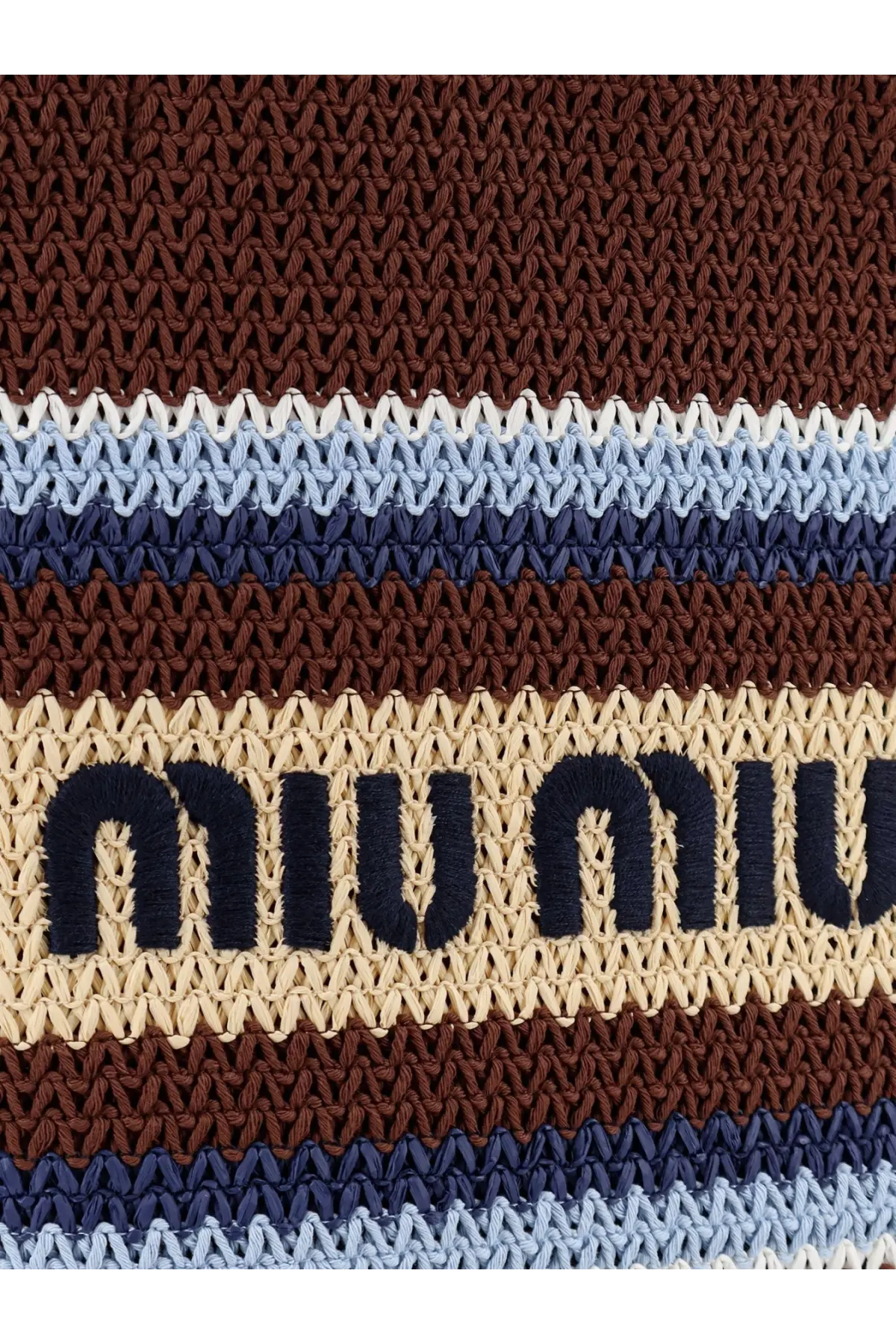 Beige and brown striped crocheted miu miu bag strap with navy blue embroidered branding on a brown knitted shopping bag