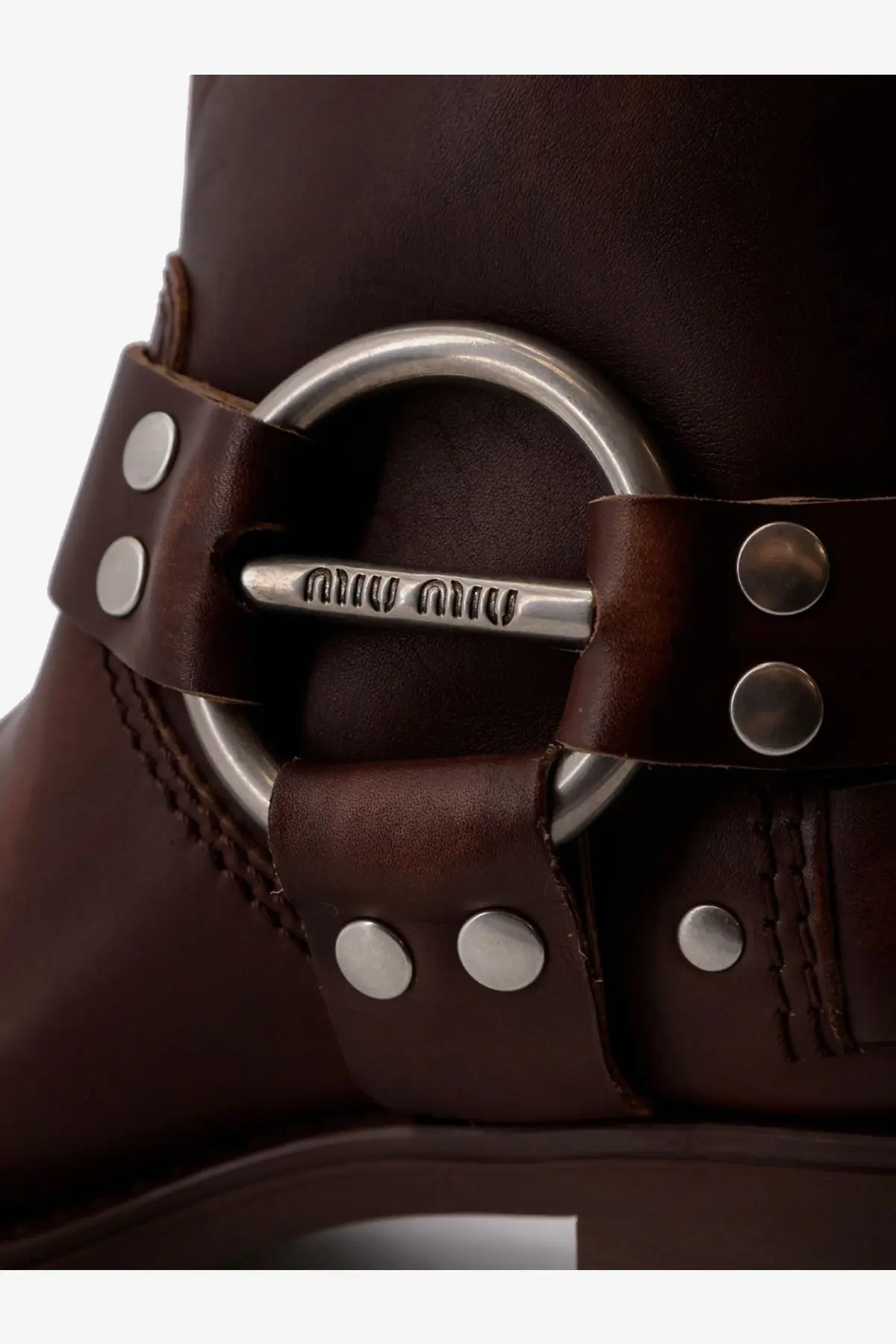 Brown leather boot with silver-toned metal buckle and stud detailing from miu miu womens leather boots collection
