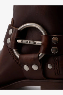 Brown leather boot with silver-toned metal buckle and stud detailing from miu miu womens leather boots collection