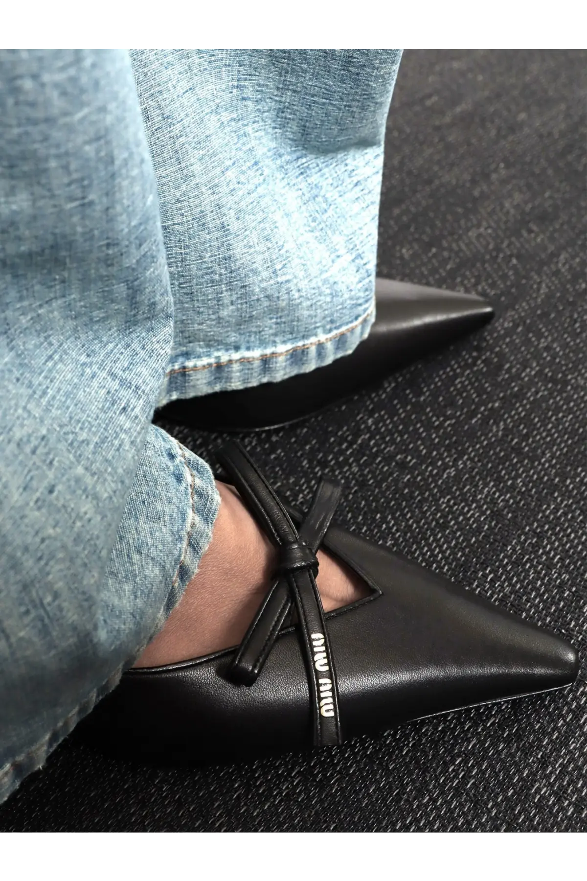 Miu Miu women’s leather écolleté black pointed-toe flats with sleek leather finish and decorative bow across instep