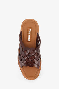 Brown woven leather miu miu slide sandal with braided strap design and tan rubber sole for women