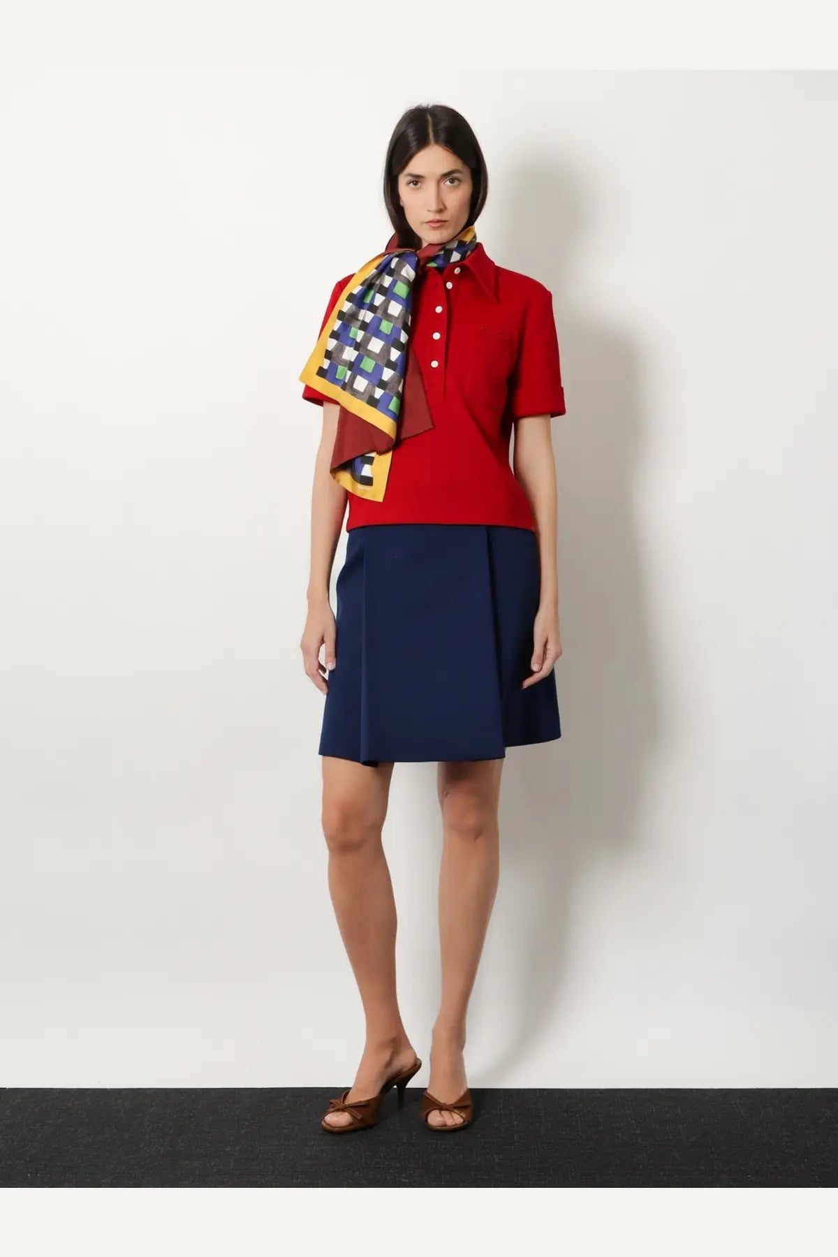 Red short-sleeved polo shirt with white buttons and collar paired with miu miu women’s multicolored silk scarf yellow