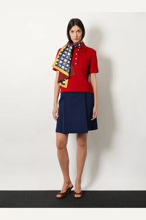 Red short-sleeved polo shirt with white buttons and collar paired with miu miu women’s multicolored silk scarf yellow