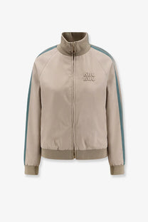 Beige Miu Miu women’s old twill track jacket with teal side stripes and matching logo patch on the chest