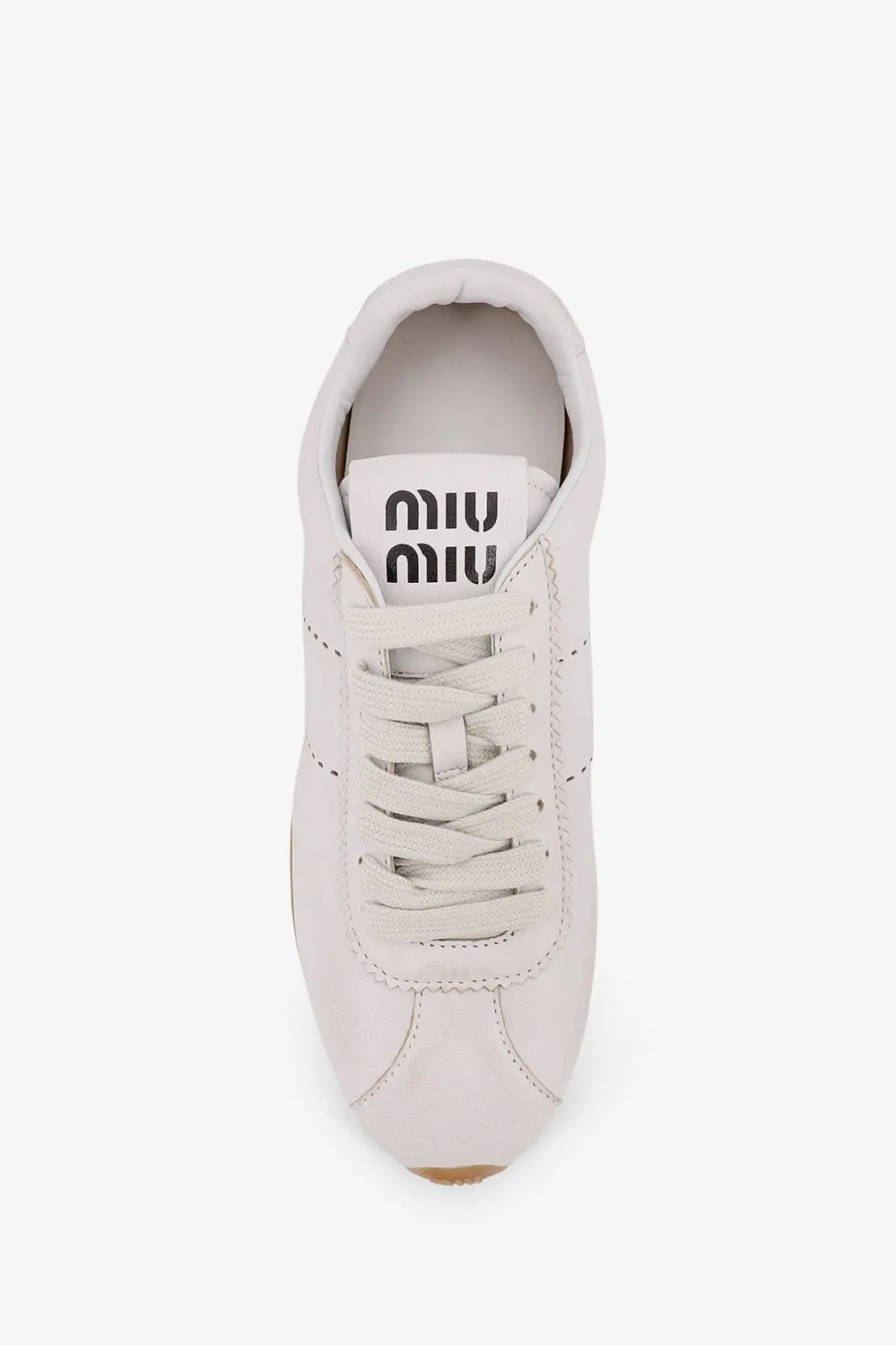 White leather miu miu women’s plume sneaker with matching laces and minimalist design