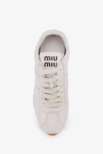 White leather miu miu women’s plume sneaker with matching laces and minimalist design