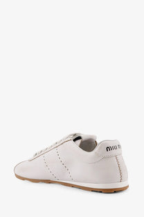 Miu Miu women’s plume white leather sneaker with tan rubber sole and black stitching details