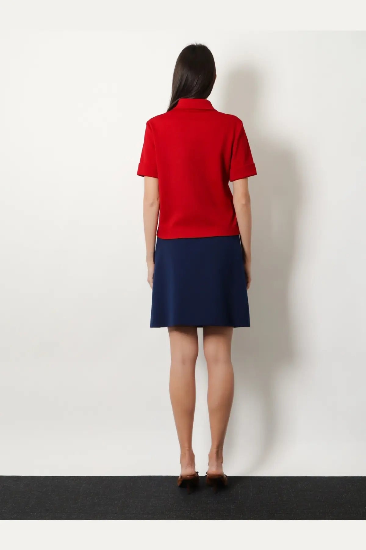 Miu Miu women’s red short-sleeved polo shirt paired with a navy blue skirt for casual and stylish wear