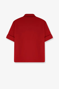 A vibrant red Miu Miu women’s polo shirt with short sleeves classic collar and neatly rolled cuffs