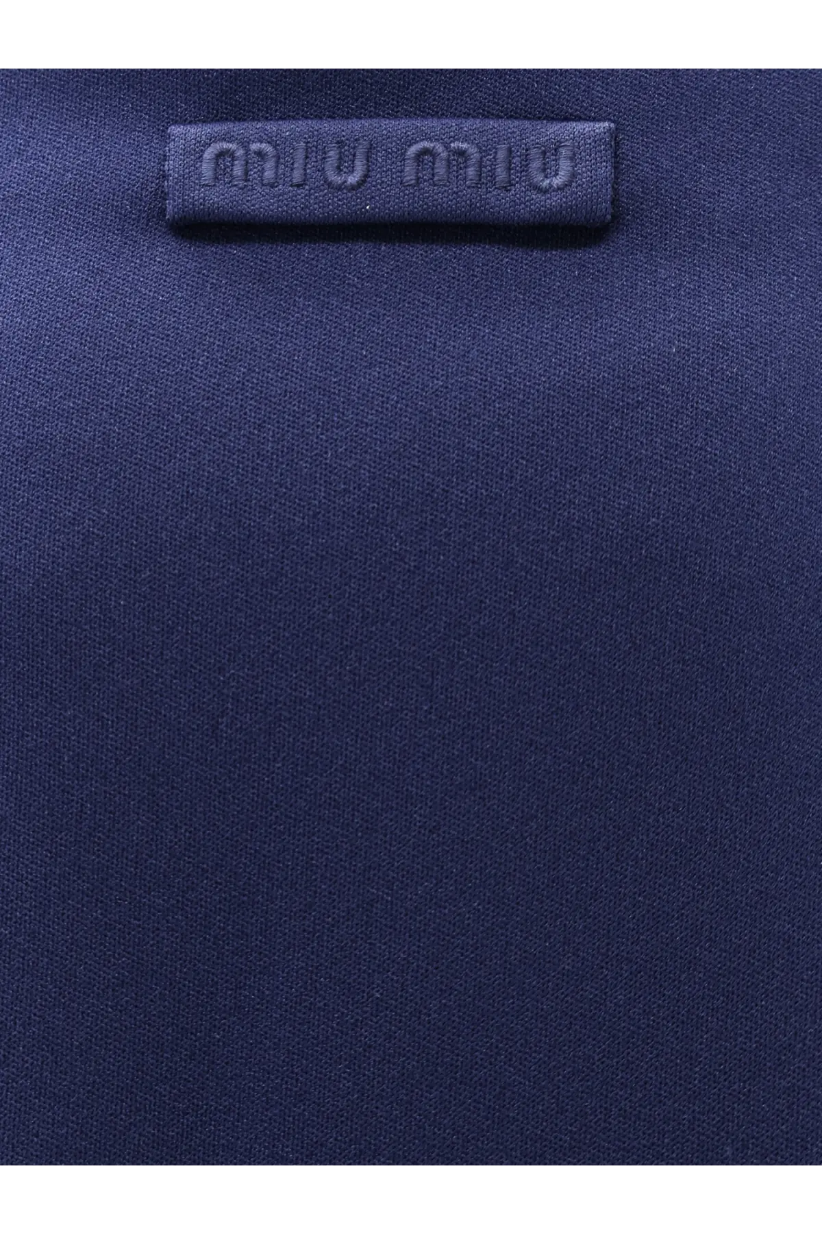 Dark blue miu miu fabric label with embossed logo on miu miu women’s skirt baltico