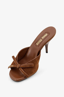 Miu Miu women’s brown suede mule sandal with bow detail on the toe strap in rovere color