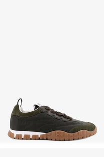 Olive green suede and leather sneaker with brown rubber sole and textured miu miu logo on the heel back side