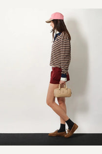 Beige leather mini handbag with top handle and front flap closure paired with miu miu women’s white virgin wool polo shirt