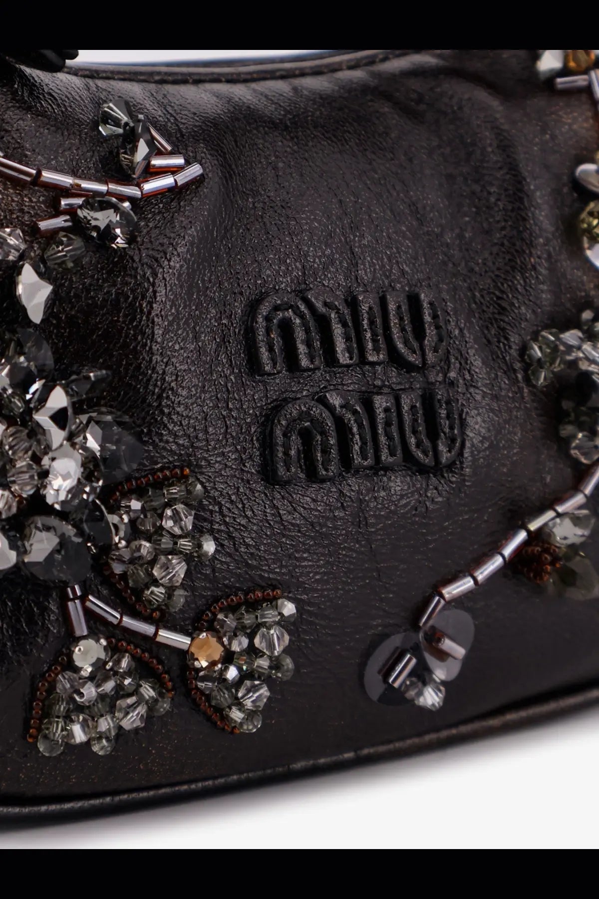 Black leather miu miu women’s wander mini crossbody bag with intricate silver and clear crystal embellishments