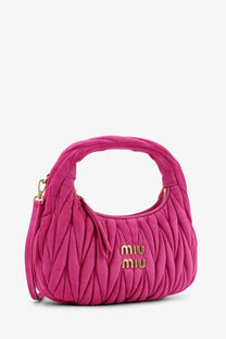 A vibrant fuchsia Miu Miu women’s Wander Matelassé suede shoulder bag with quilted texture and gold-tone logo hardware