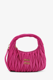 A vibrant fuchsia miu miu women’s wander matelassé suede shoulder bag with quilted texture and gold-tone logo hardware