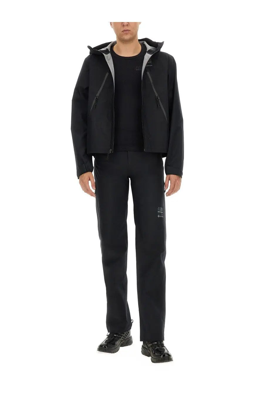 Black hooded jacket with gray inner lining and subtle branding details paired with mm6 maison margiela men’s black straight leg pants