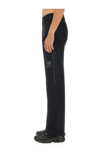 Black mm6 maison margiela men’s straight leg trousers with subtle side zipper and minimalist white thigh branding