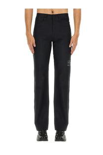 Mm6 Maison Margiela men’s straight leg black trousers with a subtle white logo patch on the lower leg