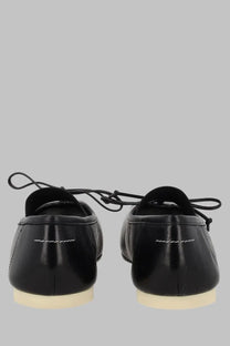 Mm6 maison margiela women’s black patent leather loafers with white stitching and cream-colored soles