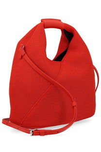 Vibrant red woven canvas tote bag with structured asymmetrical design and matching leather straps by MM6 Maison Margiela