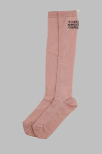A pair of pink ribbed knee-high socks with black numerical markings from mm6 maison margiela womens calzini alti con blue