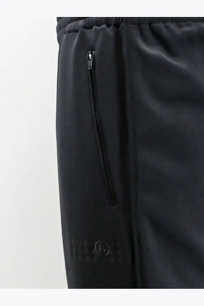 Black mm6 maison margiela women’s cotton blend jogging trousers with subtle textured fabric and side zippered pocket